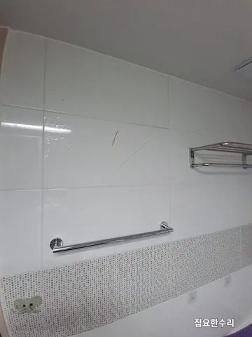 욕실 상부 흰색 벽타일에 세로로 길게 금이 간 시공 전 모습 (평촌 출장 시공)