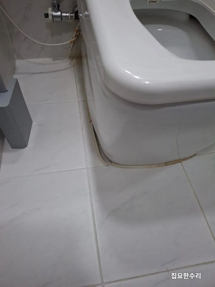 변기 옆면과 바닥 타일 사이 마감재가 들떠 틈이 벌어진 상태 (수지 출장 시공)