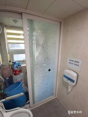 화장실 미닫이문 유리 전체가 거미줄처럼 금이 간 모습 (화성 출장 시공)
